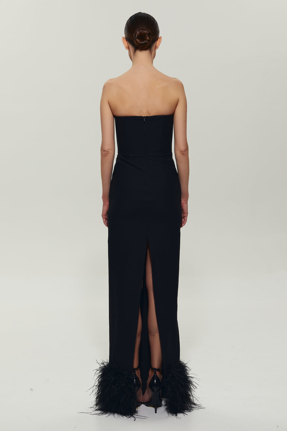 Black maxi dress with feathers on the bottom