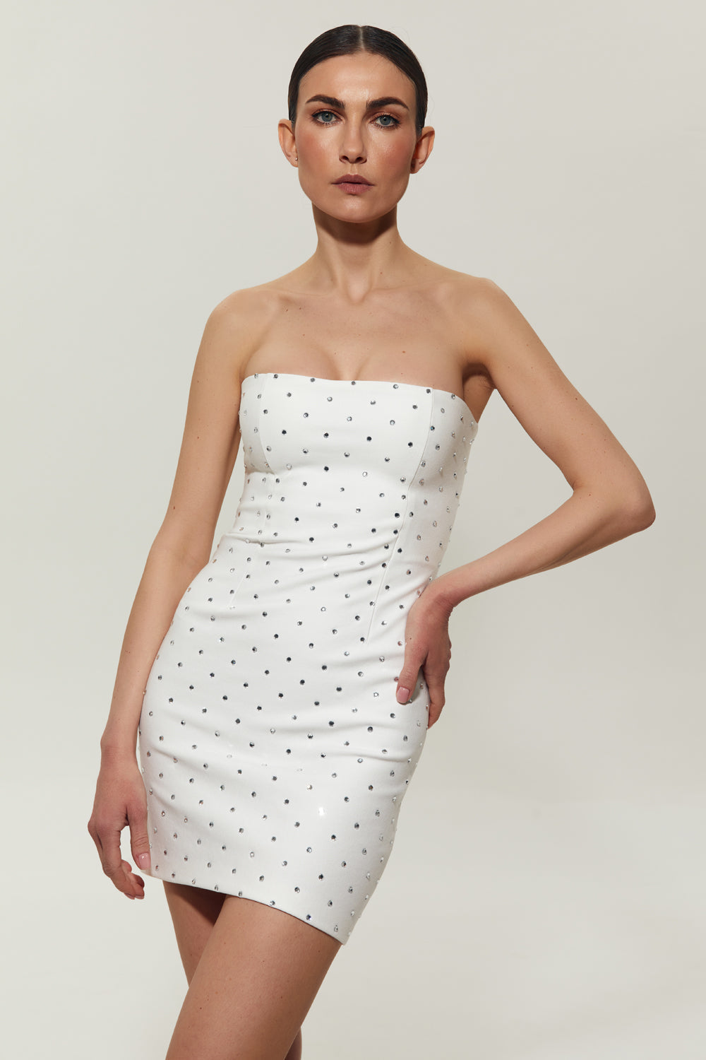Elegant woman in a curve-hugging black bandage dress ready for an evening event
