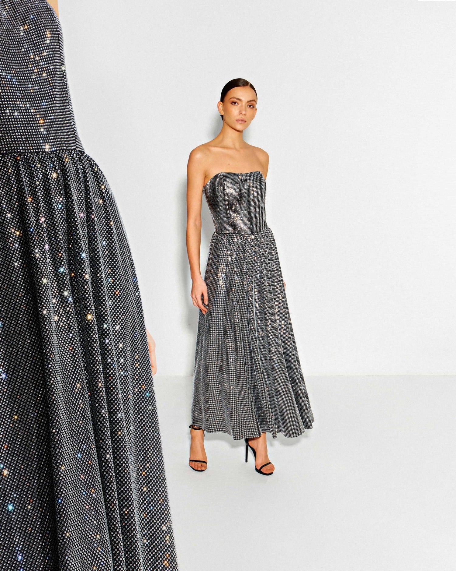 Elegant black evening dress with feathers and crystals – perfect for a luxury wedding guest look by Semenenko
