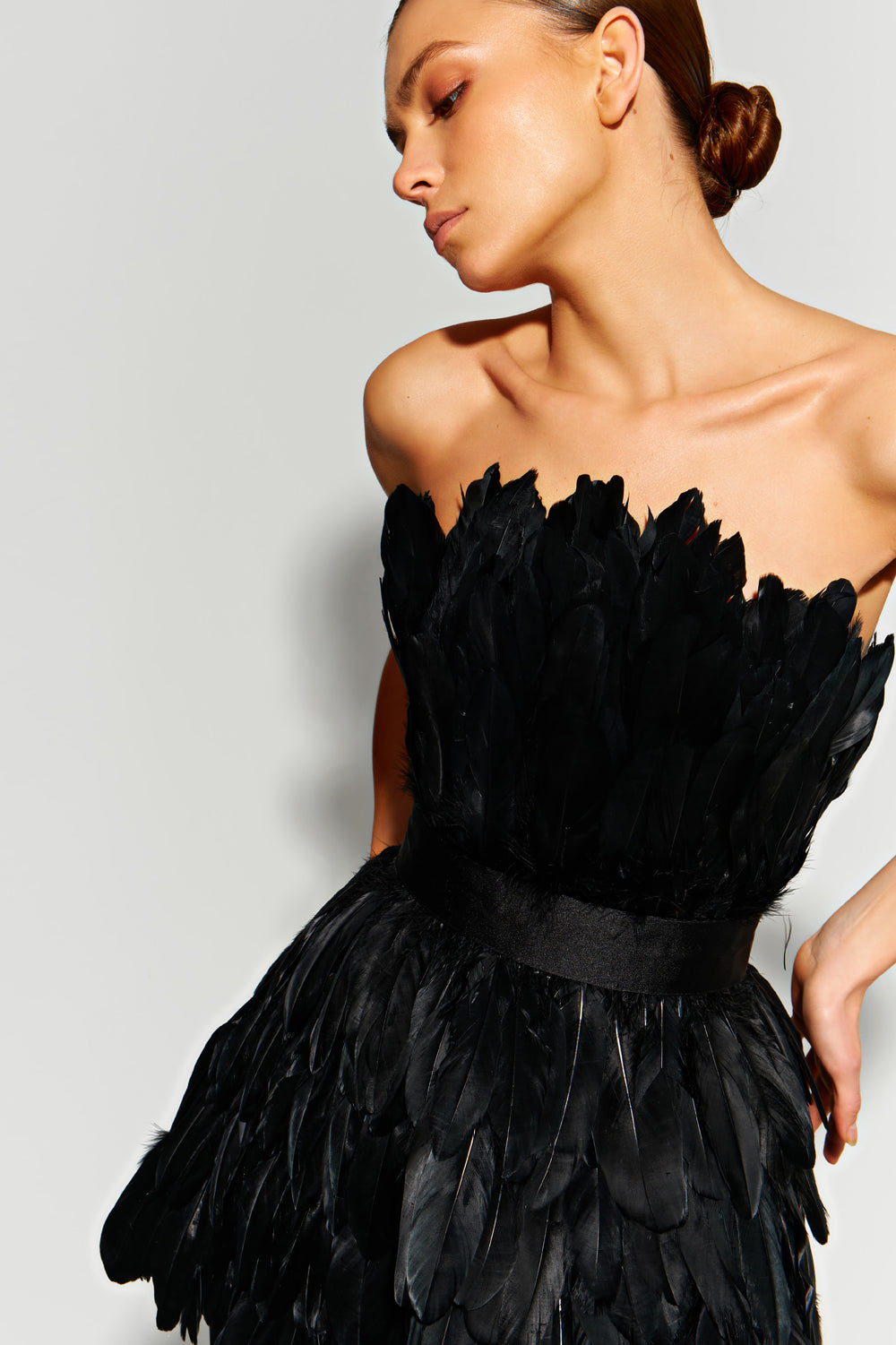 Black mini dress made of large feathers.