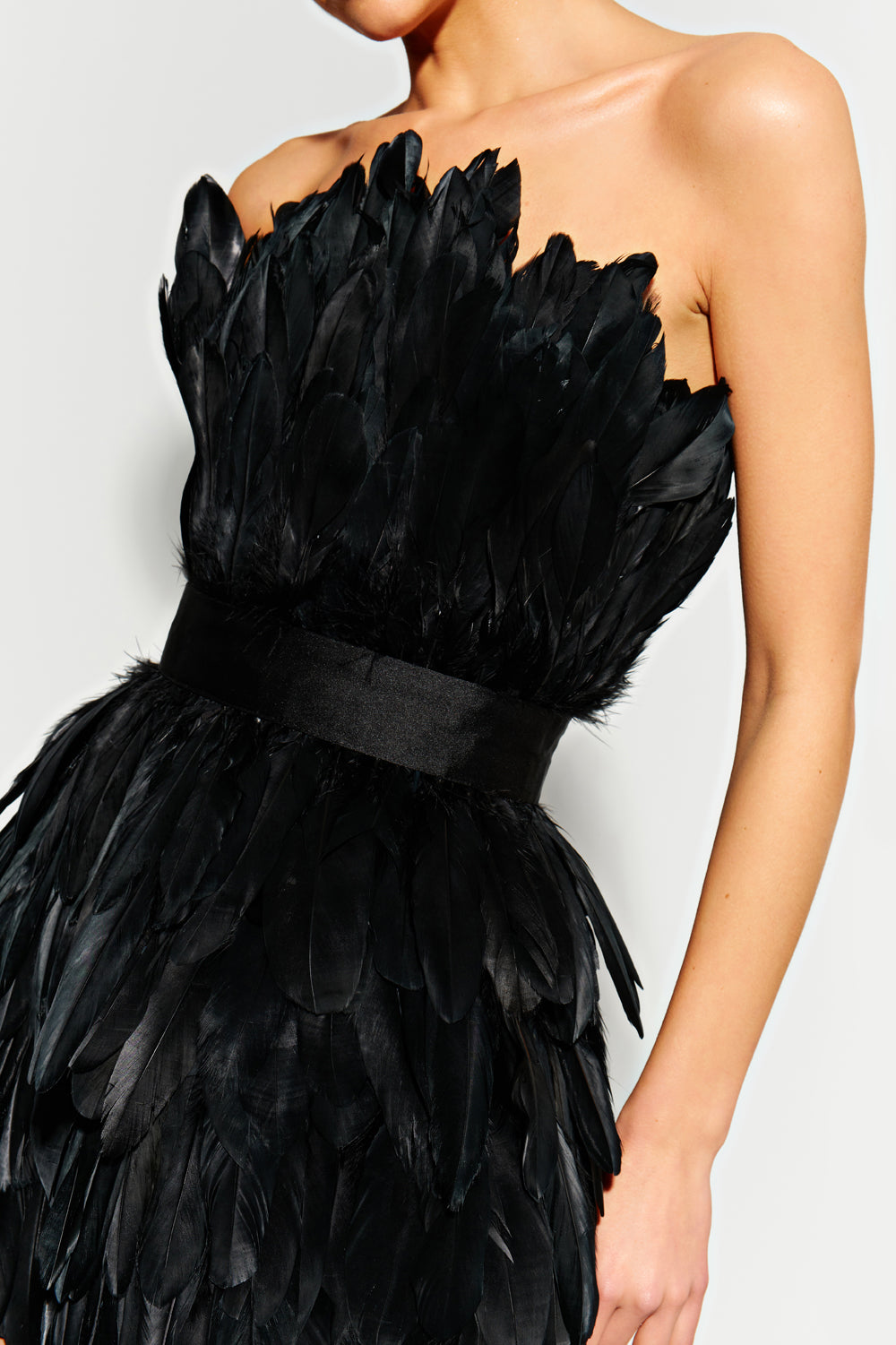 Black mini dress made of large feathers.