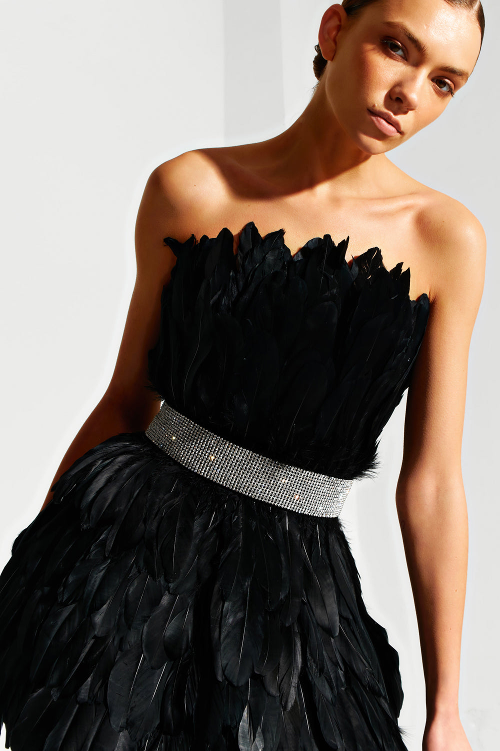 Black mini dress made of large feathers.