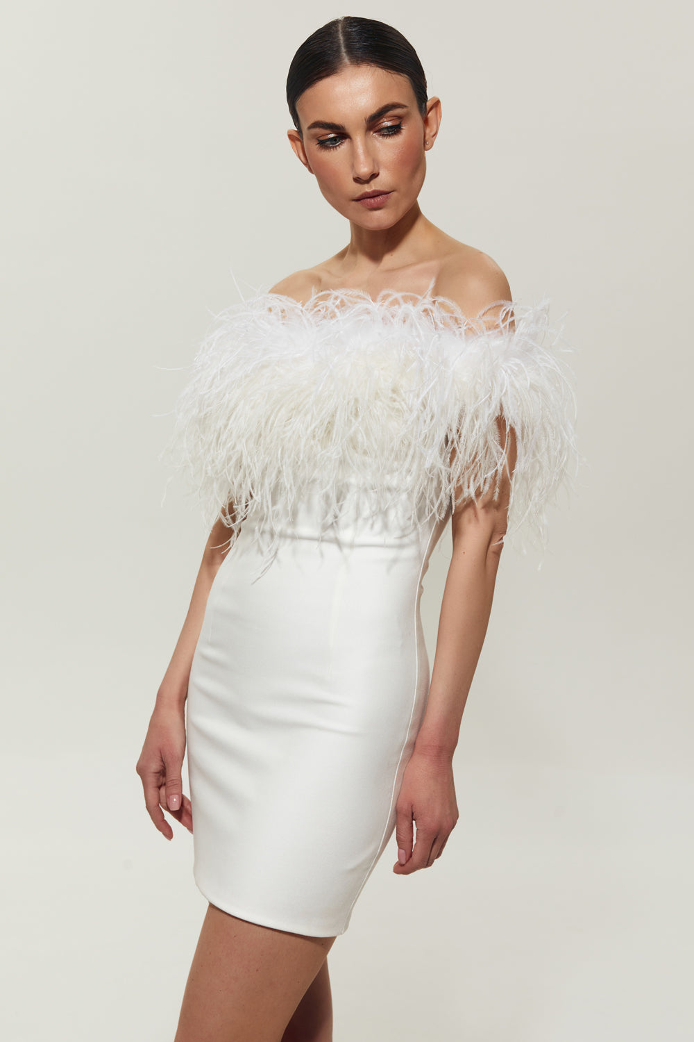 White mini costume dress with feathers on the shoulders.