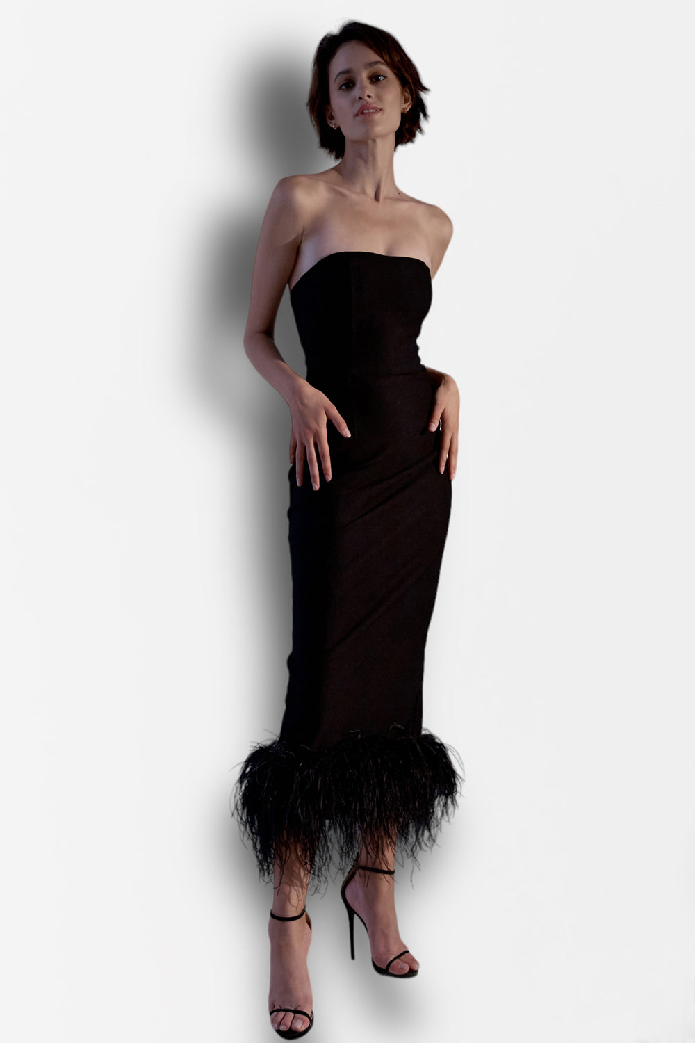 Black jersey midi dress with feathers on the bottom