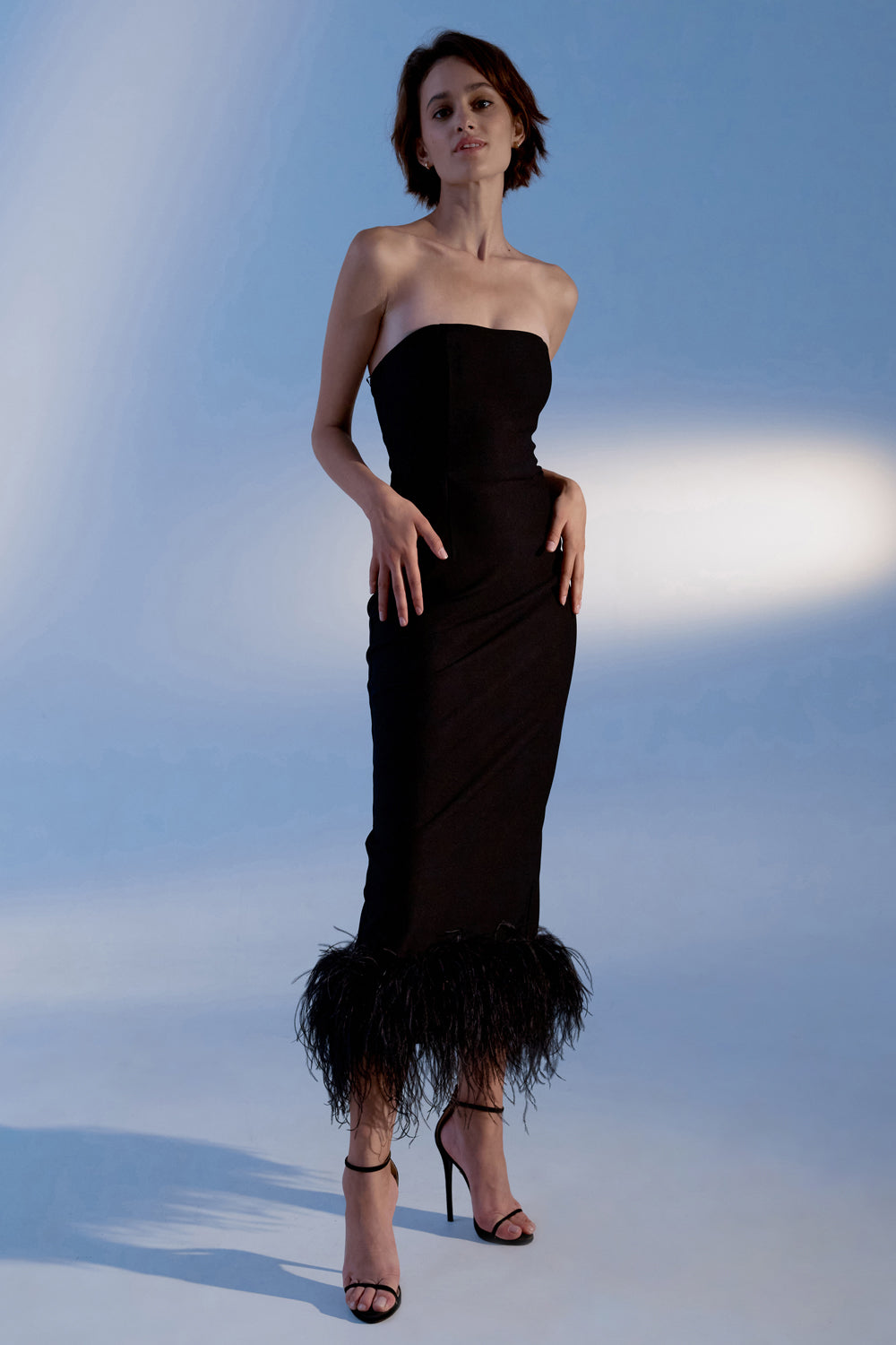 Black jersey midi dress with feathers on the bottom