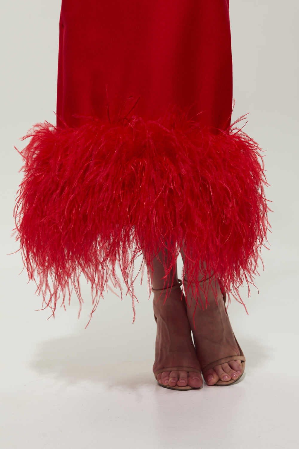 Red jersey midi dress with feathers on the bottom