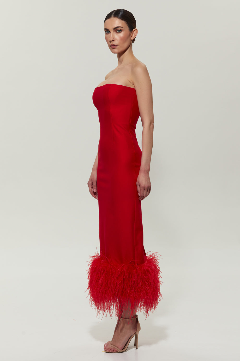 Red jersey midi dress with feathers on the bottom