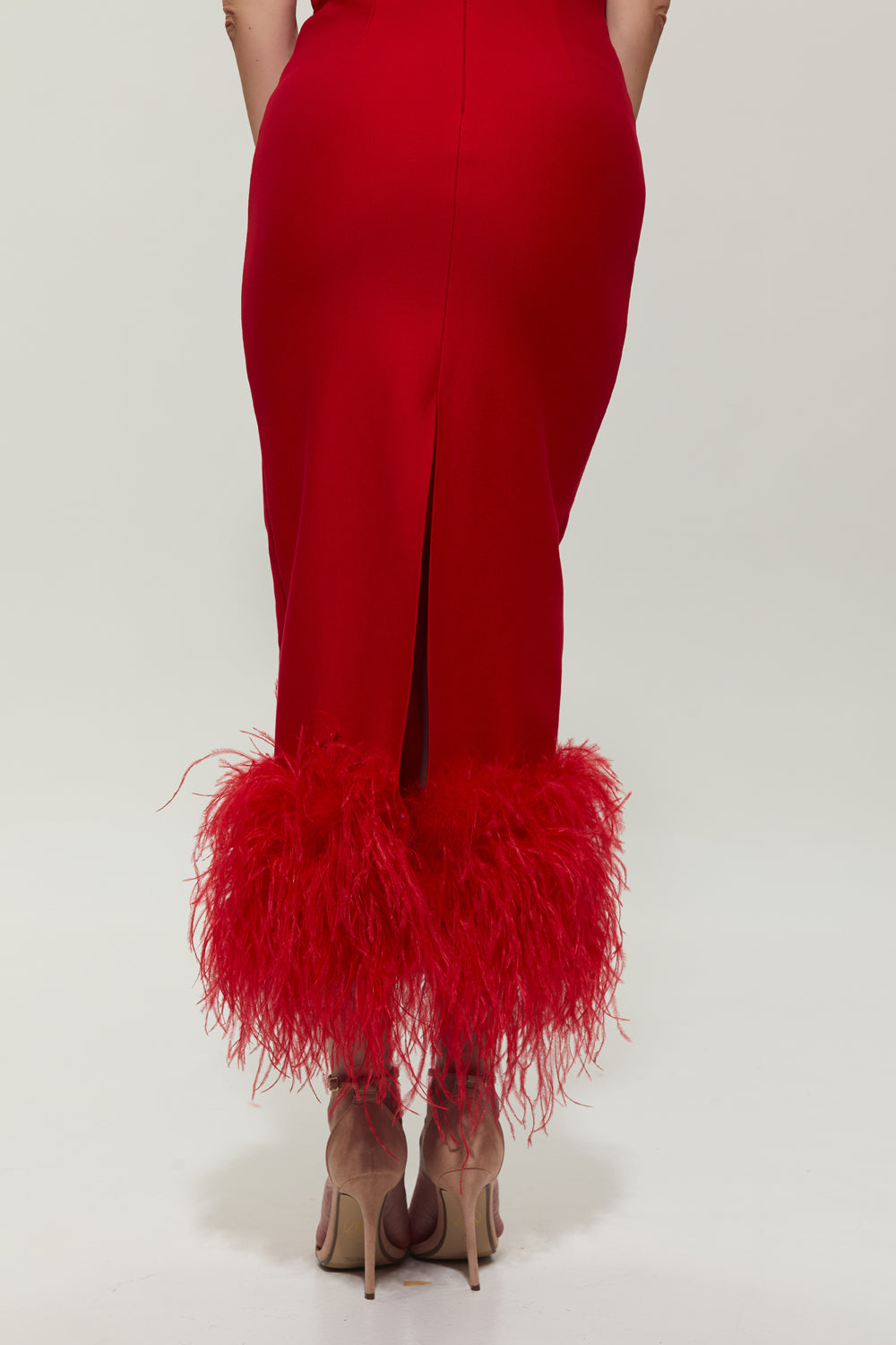 Red jersey midi dress with feathers on the bottom