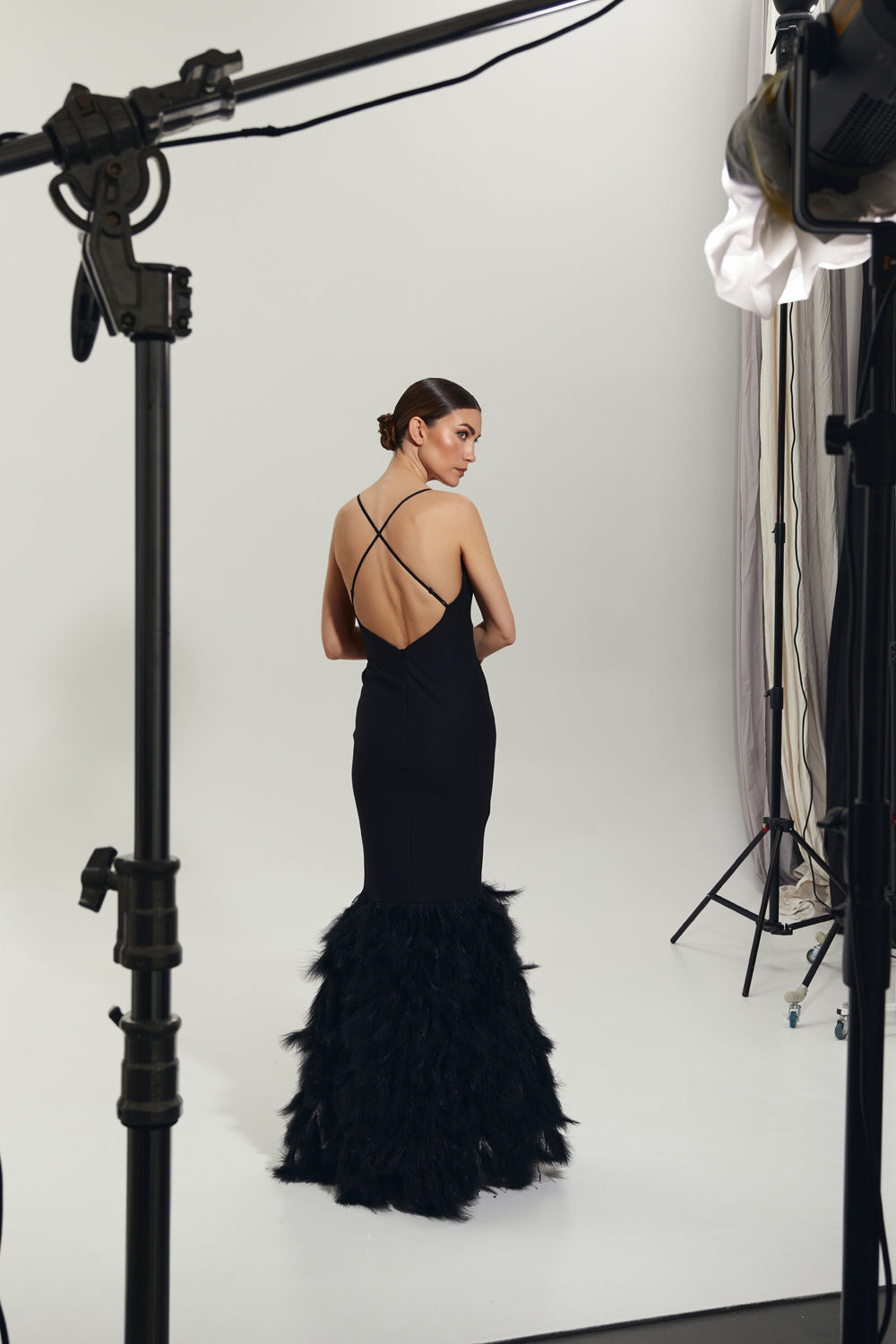 Black maxi dress with feathers on the bottom