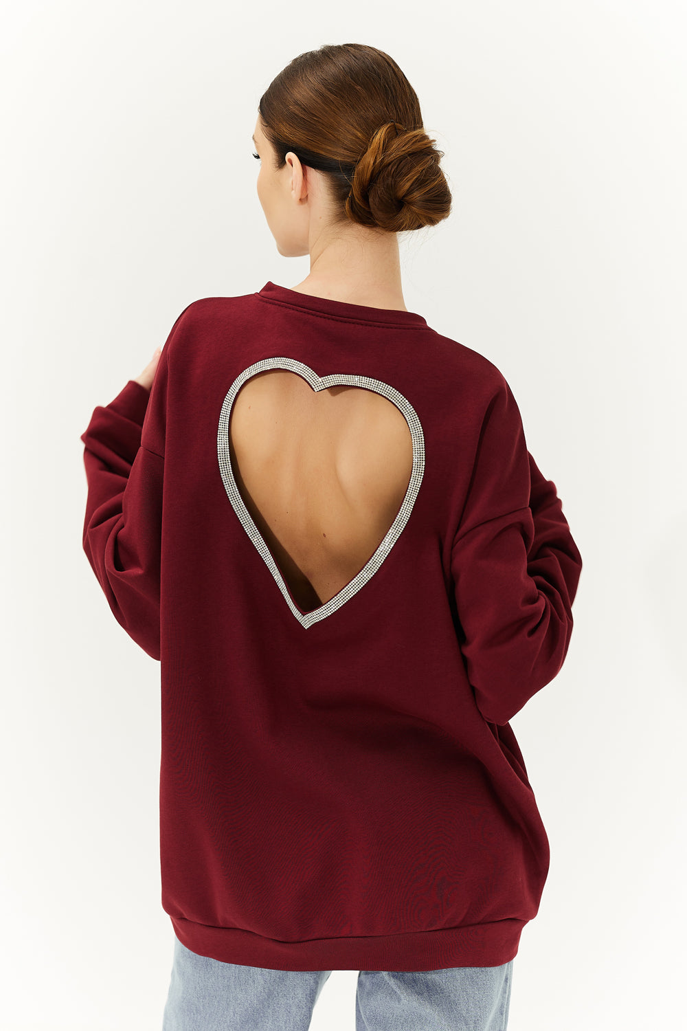 A burgundy sweatshirt with a heart on the back.