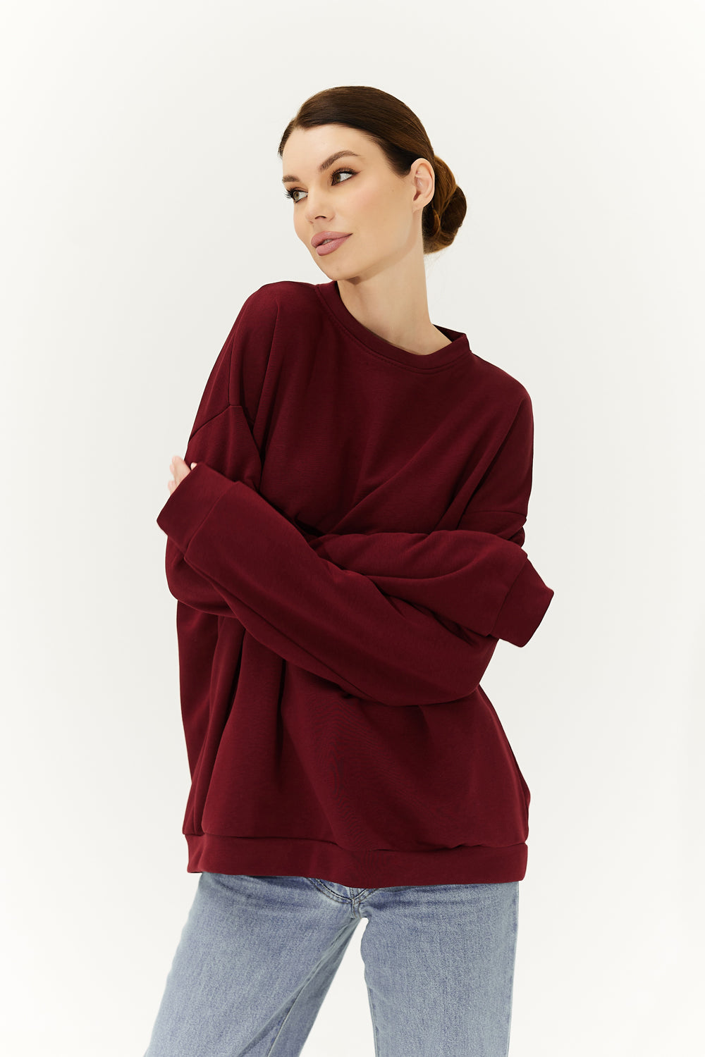 A burgundy sweatshirt with a heart on the back.